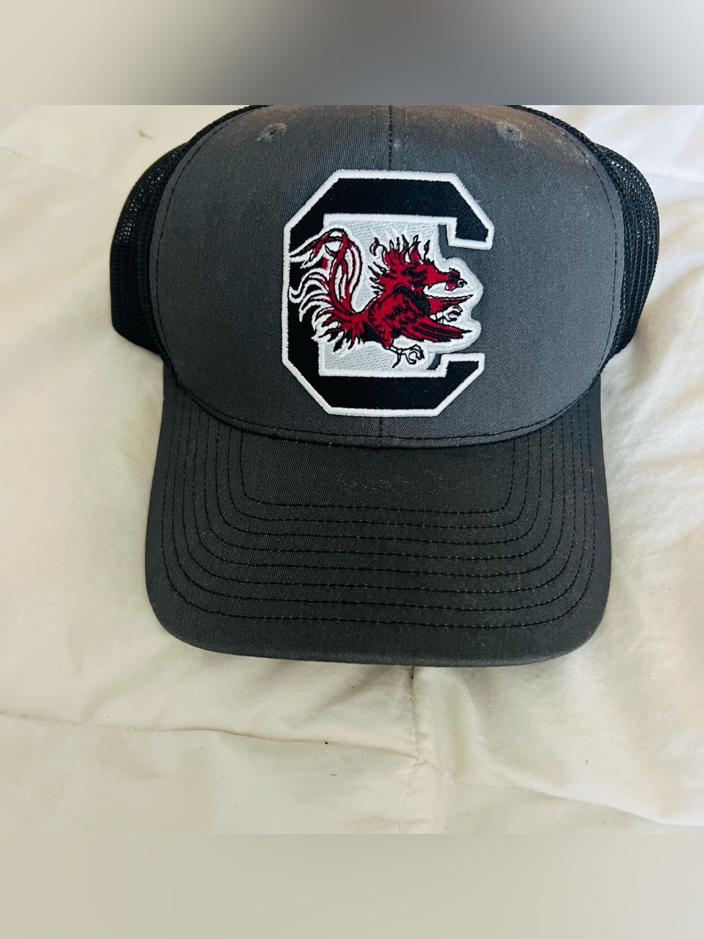 Robin Ruth Gray and Black Trucker Hat with Red Gamecock Patch